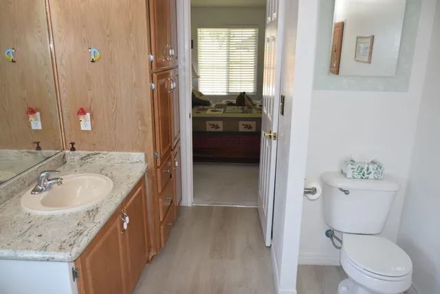 a en suite bathroom with a granite countertop sink toilet and shower