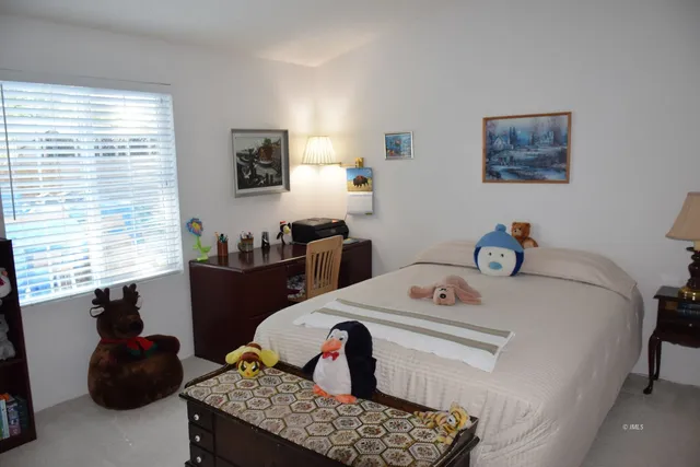 a bedroom with a bed and a table