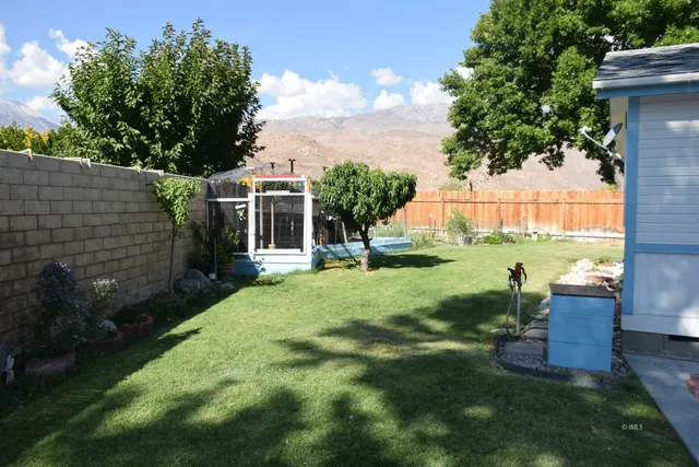 a view of house with backyard