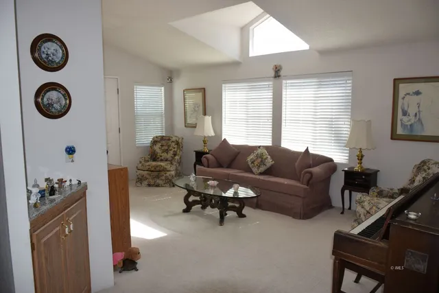 a living room with furniture a window and a closet