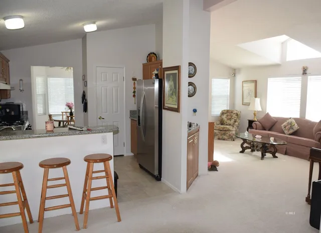 a living room with furniture and a dining table