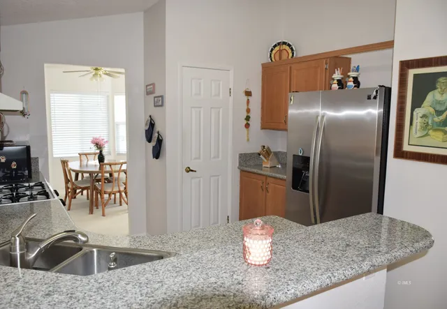 a kitchen with a table and refrigerator