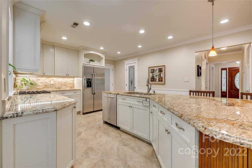 29008 Silver Fox Drive Tega Cay, SC 29708 - Photo 18 of 48 a kitchen with granite countertop refrigerator sink and cabinets