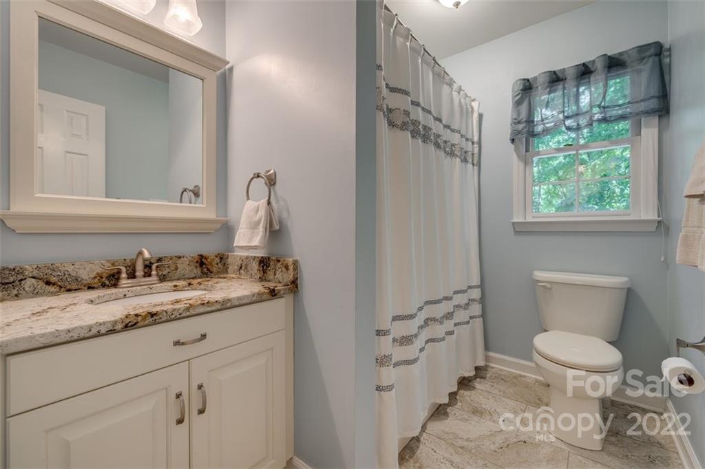 29008 Silver Fox Drive Tega Cay, SC 29708 - Photo 33 of 48 a bathroom with a granite countertop sink toilet and mirror