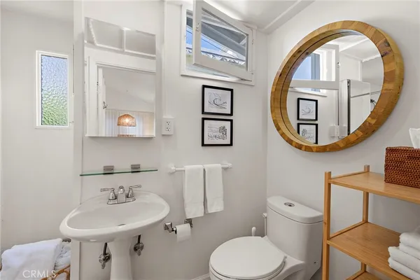 a bathroom with a toilet a sink and a mirror