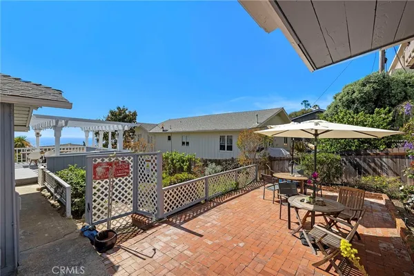 a view of a patio with a table chairs and a umbrella
