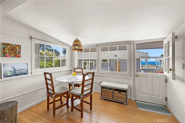 a view of a dining room with furniture window and wooden floor