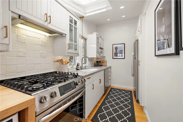 a white stove top oven sitting inside of a kitchen