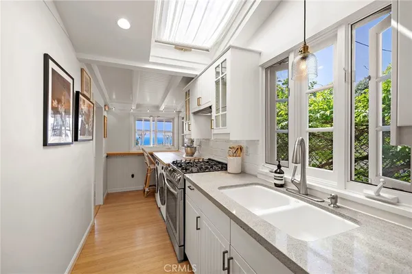 a kitchen with a sink stove and cabinets