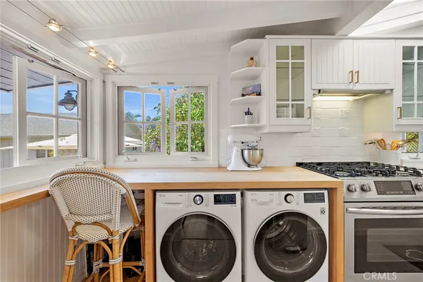 a kitchen with a stove top oven sink and cabinets