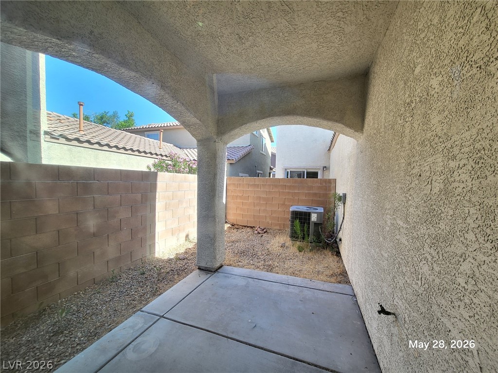 9843 West Overlook Ridge Avenue Las Vegas, NV 89148 - Photo 16 of 19 A modest covered patio offers a cool respite with concrete paving and views of adjacent residential structures.