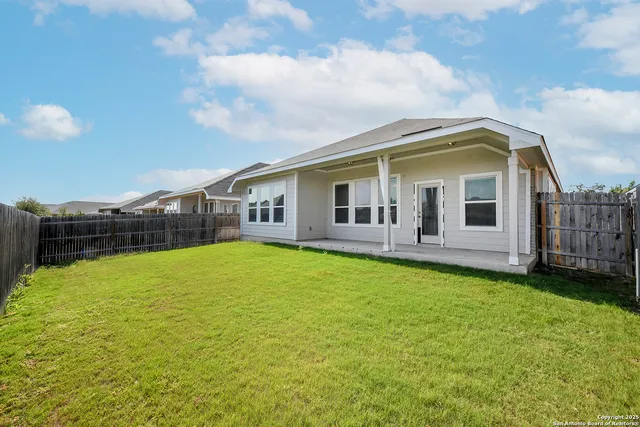 a view of a house with a backyard