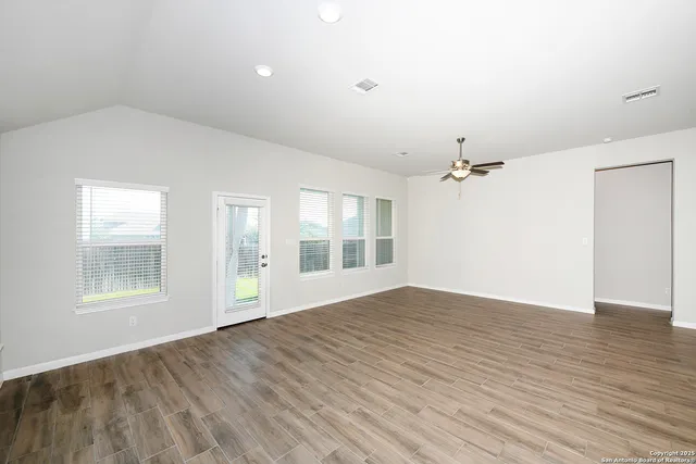 wooden floor in an empty room with a window