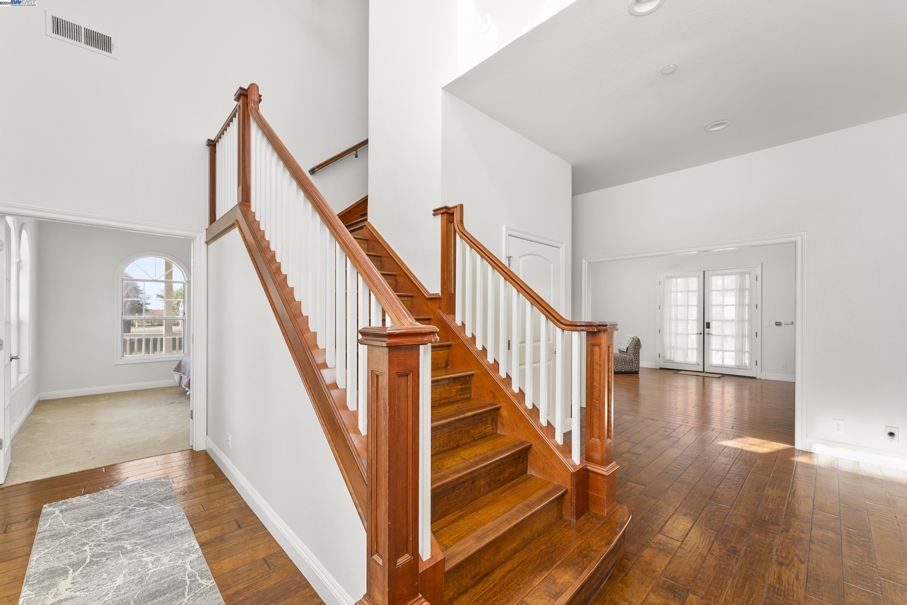 11699 Conley Road Galt, CA 95632 - Photo 16 of 31 a view of staircase with lots of frames on wall and windows