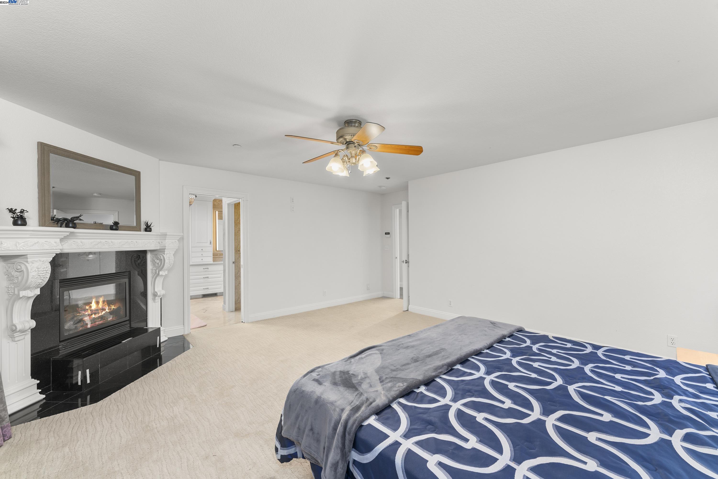 11699 Conley Road Galt, CA 95632 - Photo 17 of 31 a bedroom with a bed and a fireplace