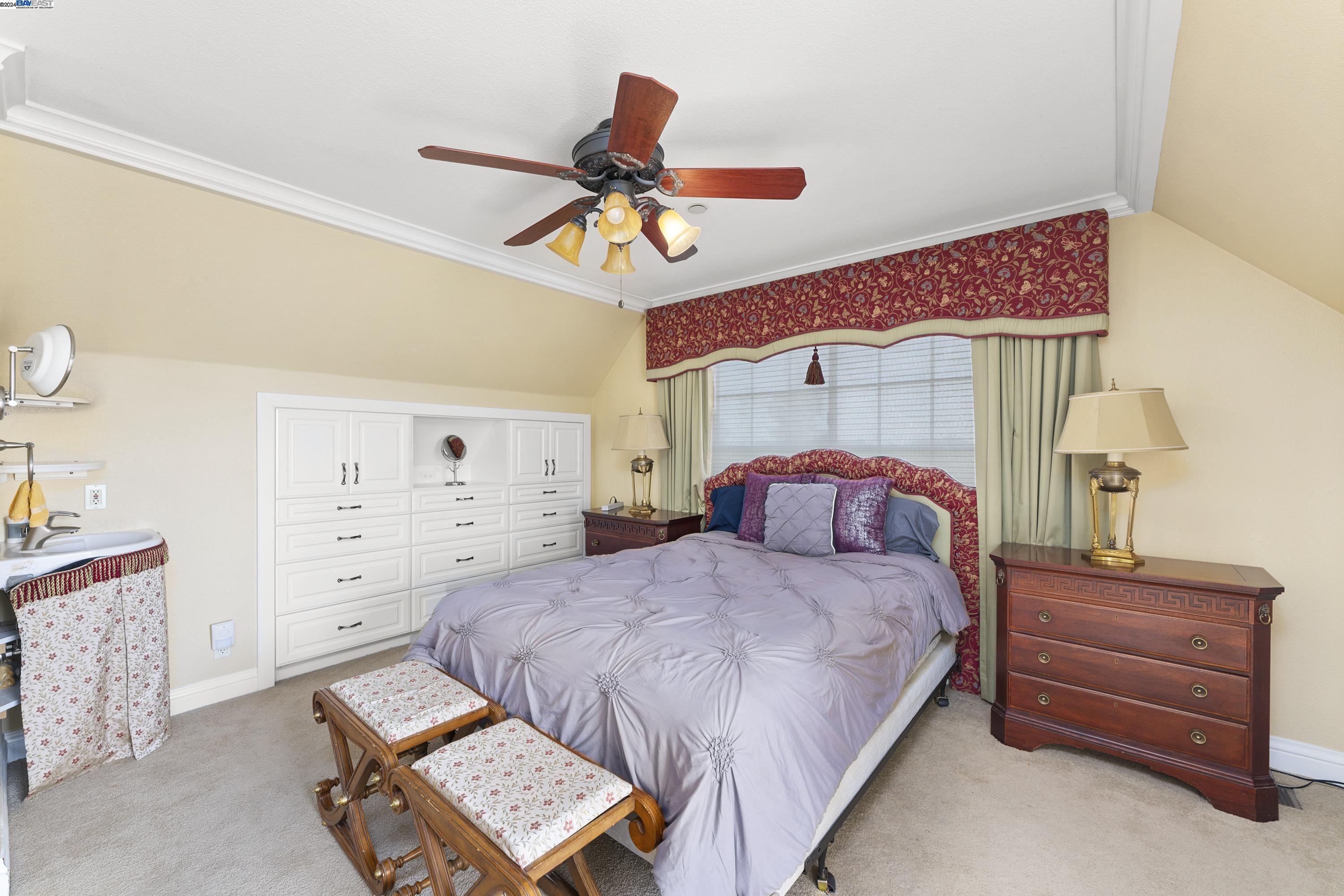 11699 Conley Road Galt, CA 95632 - Photo 29 of 31 a bedroom with a bed and a chandelier