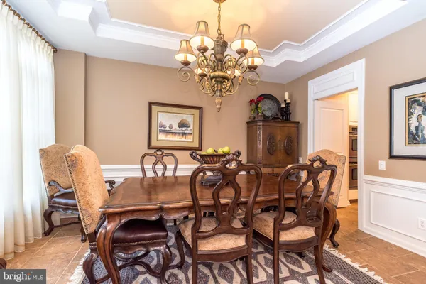 a view of a a dining room with furniture window and wooden floor