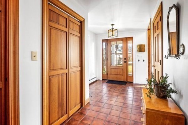12 Mitchell Avenue Scituate, MA 02066 - Photo 12 of 30 a view of a hallway with wooden floor and a bathroom