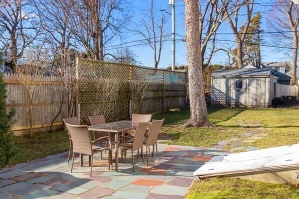 12 Mitchell Avenue Scituate, MA 02066 - Photo 8 of 30 a view of a patio with table and chairs and wooden fence