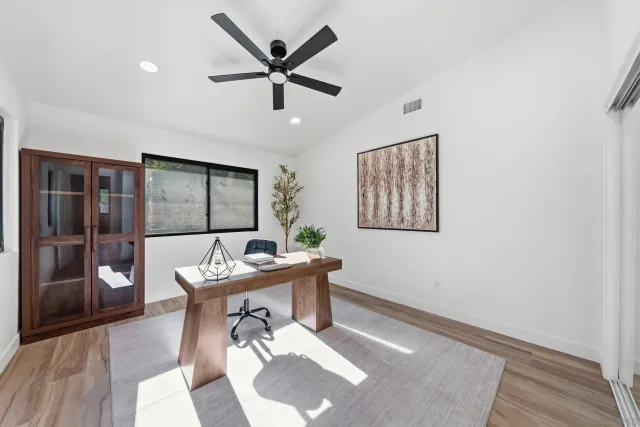 a spacious bedroom with a large bed and a large window