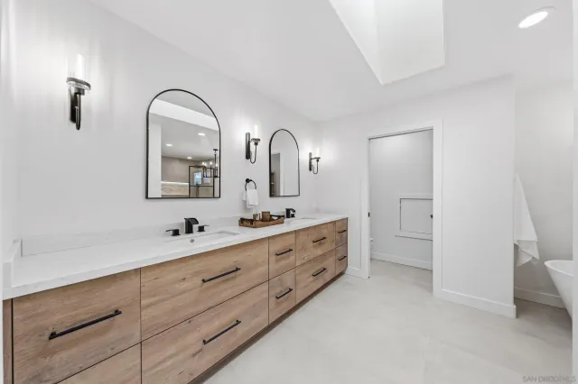 a white bath tub sitting in a en suite bathroom