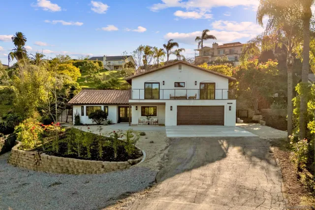 a view of a house with a yard in front of it