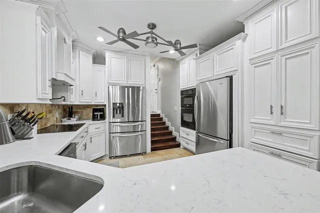 a kitchen that has a refrigerator and a sink