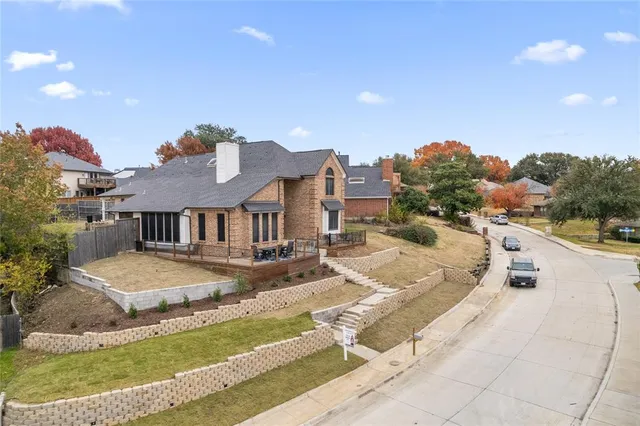 a view of a house with a yard and sitting area