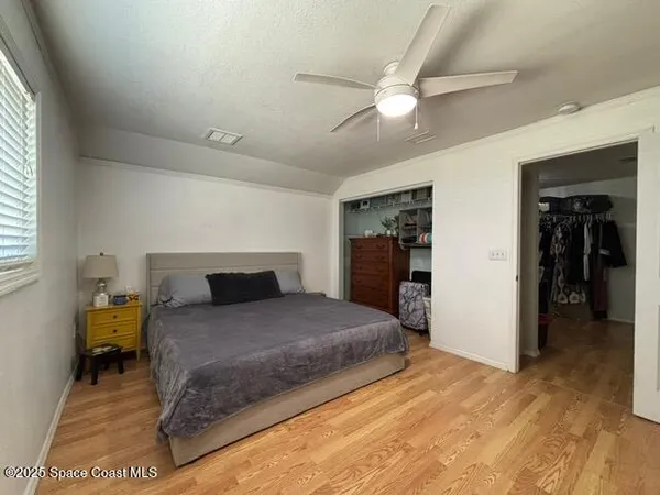 a bed room with a bed and a television