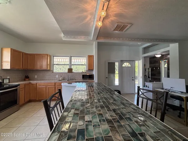 a kitchen with sink a microwave and cabinets