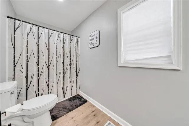 a bed room with a bed and a large window