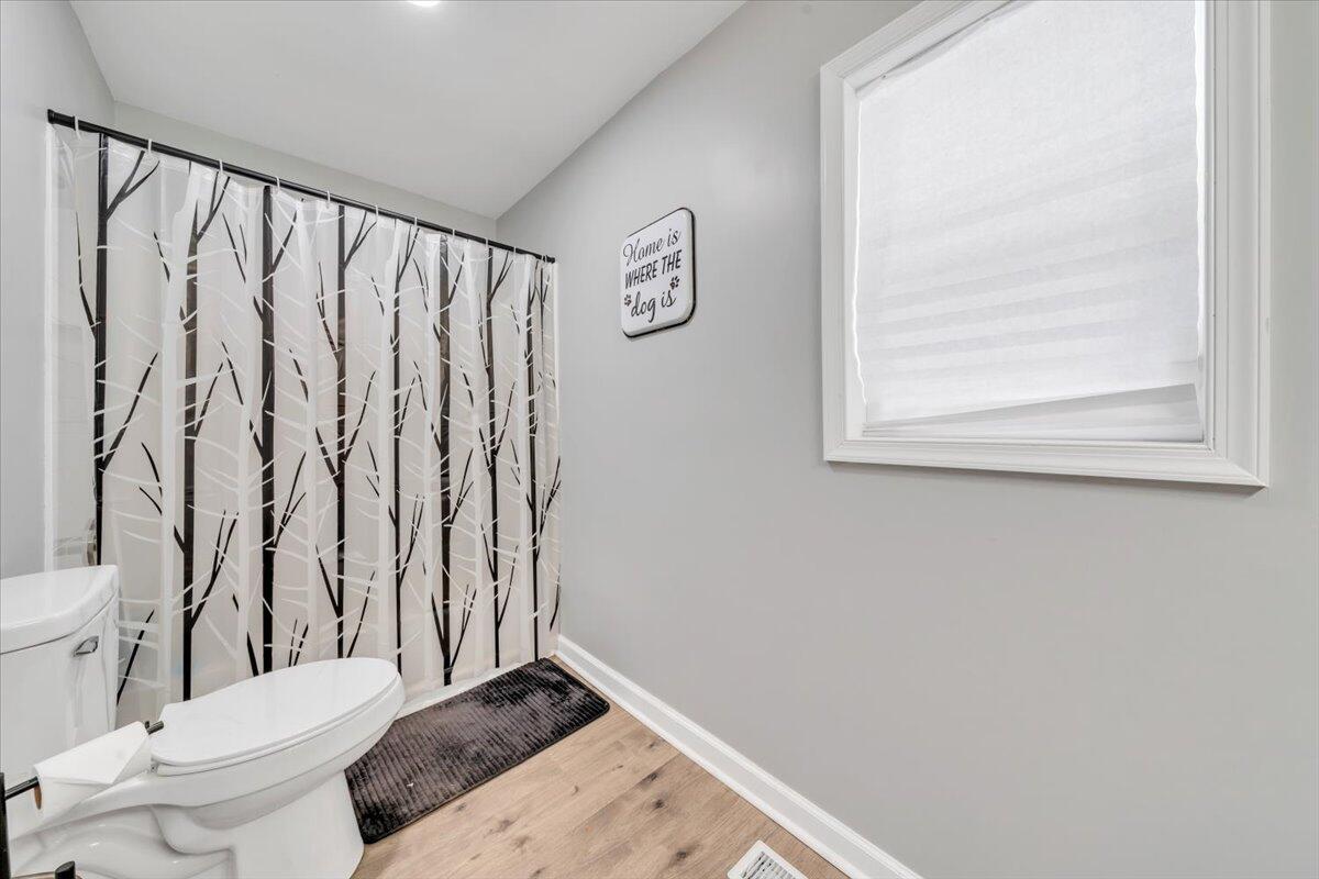 1178 Preston Mill Road Huddleston, VA 24104 - Photo 12 of 28 a bathroom with a toilet and a shower curtain