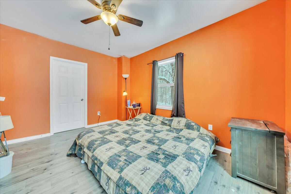 1178 Preston Mill Road Huddleston, VA 24104 - Photo 14 of 28 a bedroom with a bed and a chandelier