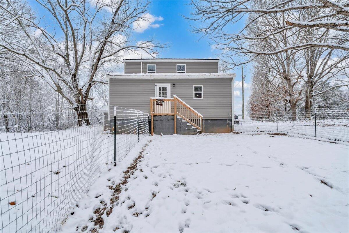 1178 Preston Mill Road Huddleston, VA 24104 - Photo 22 of 28 a view of a house with a yard covered in snow
