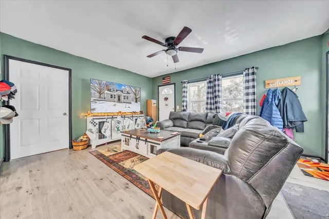 a living room with furniture a rug and a large window