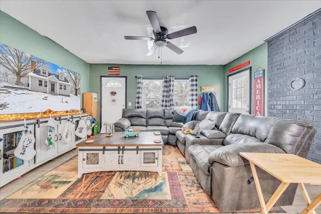 a living room with furniture a large window and a rug