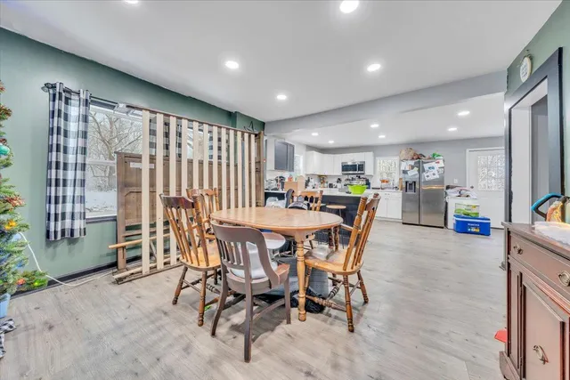 a view of a dining room with furniture and a potted plant