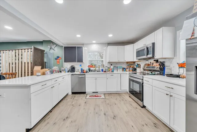 a kitchen with a refrigerator and a sink