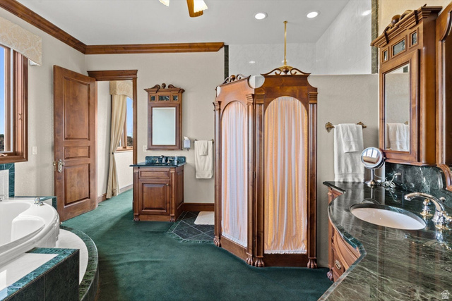 5615 East Eight Mile Gap Road Kanab, UT 84741 - Photo 23 of 81 Bathroom featuring two vanities, dark colored carpet, a bath, and ornamental molding