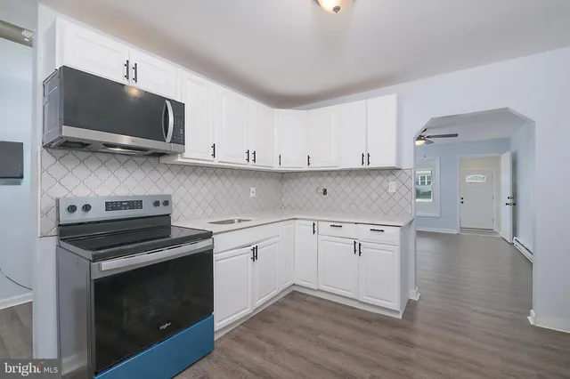 a kitchen with stainless steel appliances a stove a microwave and cabinets