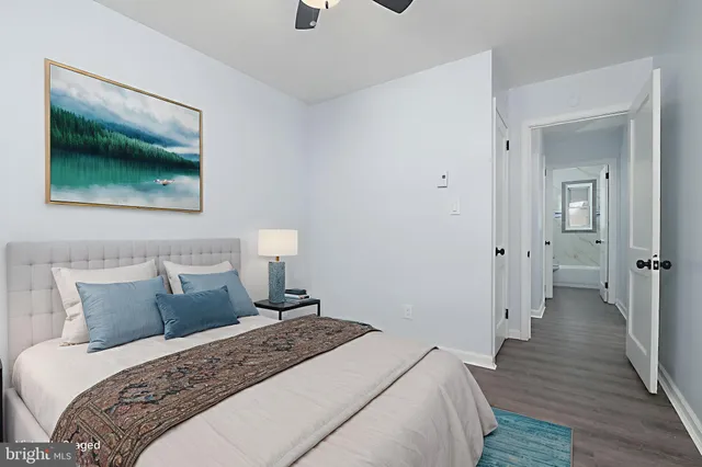 a bedroom with a bed and a painting on the wall