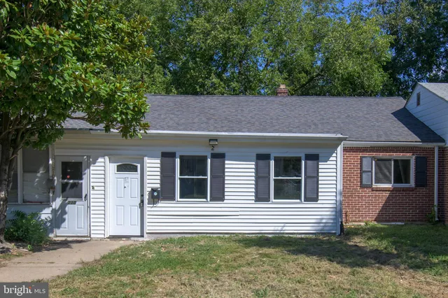 a house that has a large tree in front of it