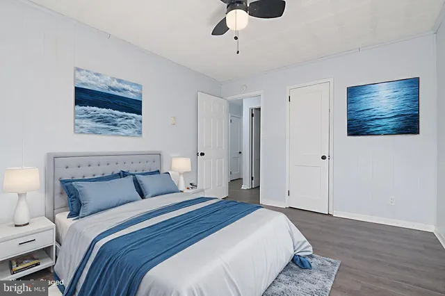 a bedroom with bed and a painting on the wall