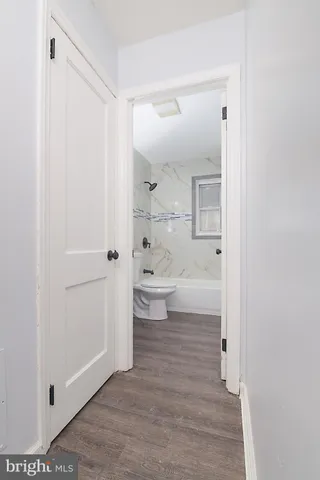 a bathroom with a toilet tub and shower