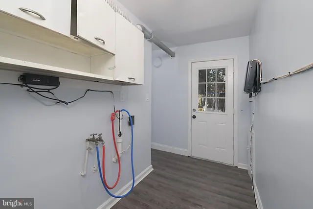 a view of a room with rack and white walls