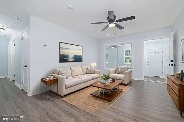 a living room with furniture rug and wooden floor