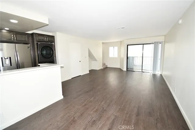 a view of a utility room with wooden floor and a window