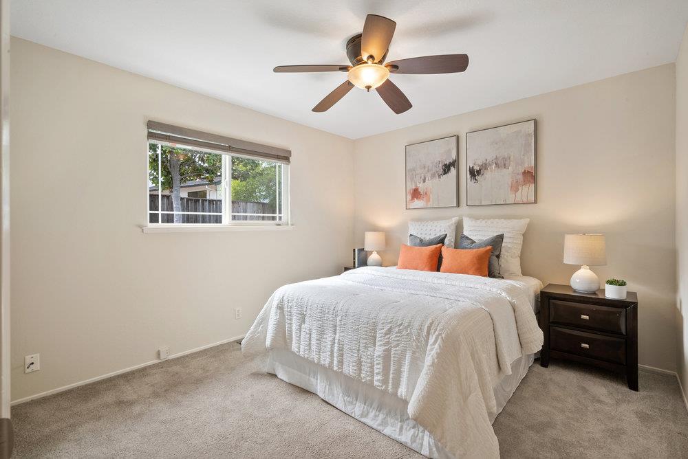 1121 Yorkshire Drive Cupertino, CA 95014 - Photo 16 of 30 a bedroom with a bed and a chandelier