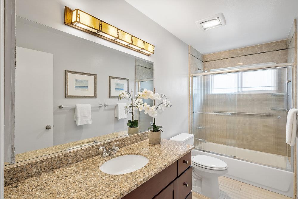 1121 Yorkshire Drive Cupertino, CA 95014 - Photo 20 of 30 a bathroom with a granite countertop sink toilet and shower