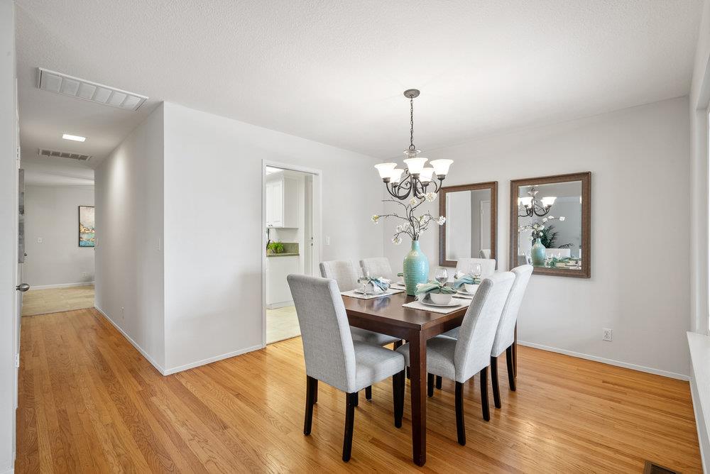 1121 Yorkshire Drive Cupertino, CA 95014 - Photo 9 of 30 a view of a dining room with furniture a chandelier and wooden floor